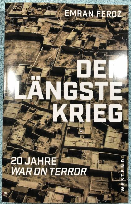 Buchcover der laengste krieg mit Vogelperspektive auf Flachdachgebaude