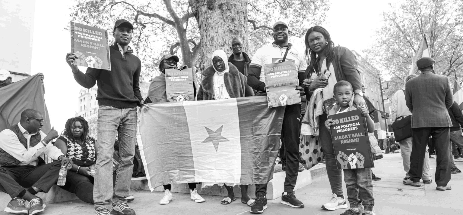 Protestierende in London halten Schilder und Plakate gegen das harte Vorgehen Senegals gegen die Opposition.